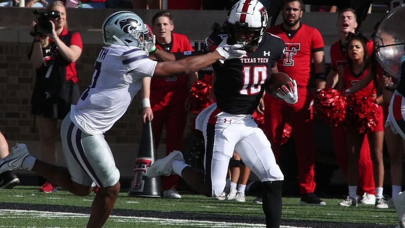 Oct 23, 2021; Lubbock, Texas, USA;  Texas Tech Red Raiders kick returner Kaylon Geiger Sr. (10) returns a kick against Kansas State Wildcats defensive back TJ Smith (7) in the first half at Jones AT&T Stadium. Mandatory Credit: Michael C. Johnson-USA TODAY Sports