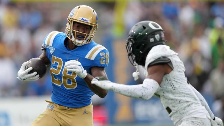 Oct 23, 2021; Pasadena, California, USA; UCLA Bruins running back Brittain Brown (28) carries the ball against the Oregon Ducks in the first half at Rose Bowl. Mandatory Credit: Kirby Lee-USA TODAY Sports