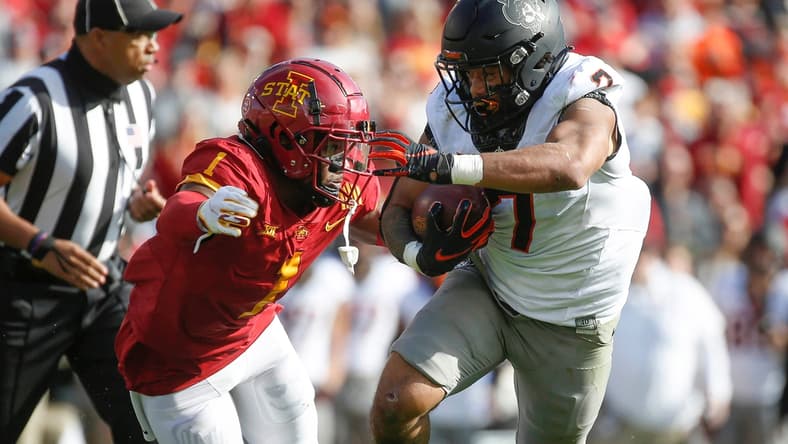 Oklahoma State senior running back Jaylen Warren runs the ball as Iowa State sophomore defensive back Isheem Young applies defense in the first quarter on Saturday, Oct. 23, 2021, at Jack Trice Stadium in Ames.

20211023 Iowastatevsokst