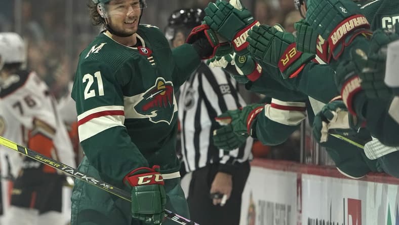 Oct 23, 2021; Saint Paul, Minnesota, USA; Minnesota Wild forward Brandon Duhaime (21) celebrates after scoring a goal against the Anaheim Ducks during the first period at Xcel Energy Center. Mandatory Credit: Nick Wosika-USA TODAY Sports