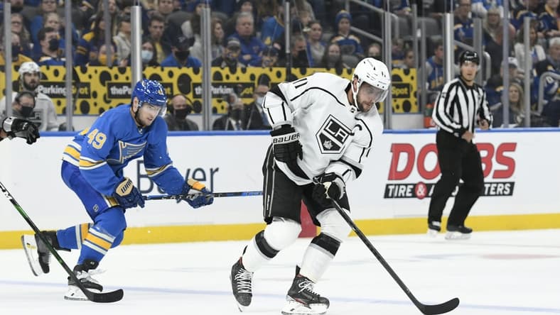 Oct 23, 2021; St. Louis, Missouri, USA; Los Angeles Kings center Anze Kopitar (11) controls the puck from St. Louis Blues center Ivan Barbashev (49) in the first period at Enterprise Center. Mandatory Credit: Jeff Le-USA TODAY Sports