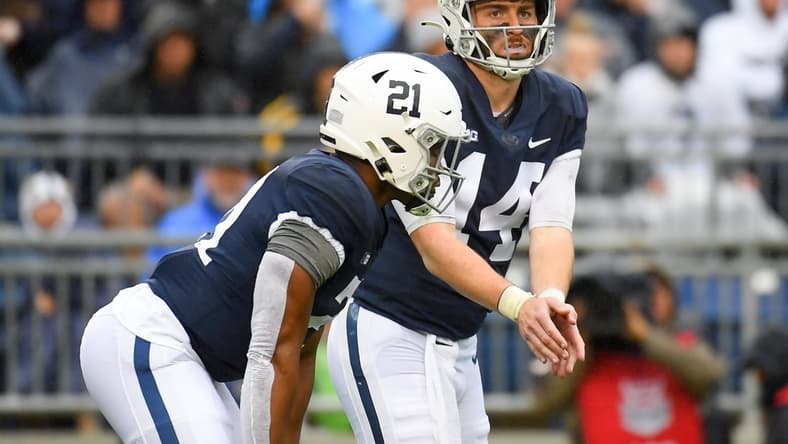 Oct 23, 2021; University Park, Pennsylvania, USA; Penn State Nittany Lions quarterback Sean Clifford (14) calls a play as running back Noah Cain (21) looks on against the Illinois Fighting Illini during the first half at Beaver Stadium. Mandatory Credit: Rich Barnes-USA TODAY Sports
