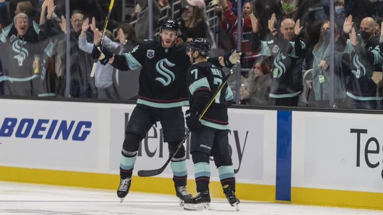 Oct 26, 2021; Seattle, Washington, USA; Seattle Kraken defenseman Jamie Oleksiak (24) and right wing Jordan Eberle (7) celebrate a goal during the first period against the Montreal Canadiens at Climate Pledge Arena. Mandatory Credit: Stephen Brashear-USA TODAY Sports