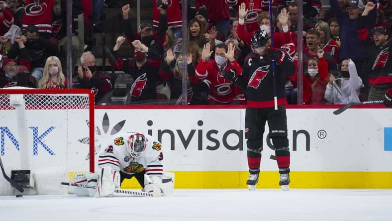 Oct 29, 2021; Raleigh, North Carolina, USA;  Carolina Hurricanes center Jordan Staal (11) celebrates his first period goal past Chicago Blackhawks goaltender Kevin Lankinen (32) at PNC Arena. Mandatory Credit: James Guillory-USA TODAY Sports