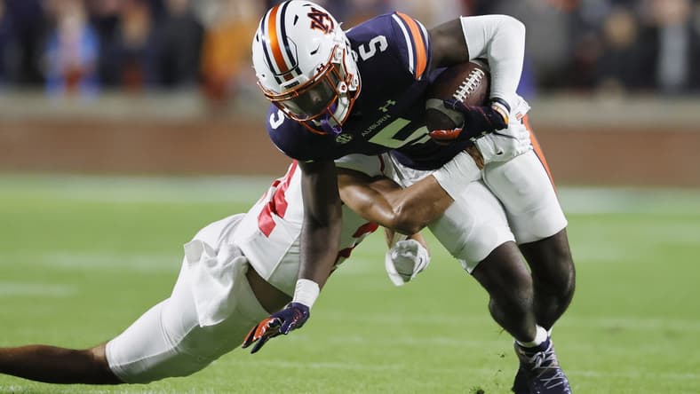 Oct 30, 2021; Auburn, Alabama, USA; Auburn Tigers wide receiver Kobe Hudson (5) is tackled by Mississippi Rebels defensive back Deane Leonard (24) during the first quarter at Jordan-Hare Stadium.  Mandatory Credit: John Reed-USA TODAY Sports