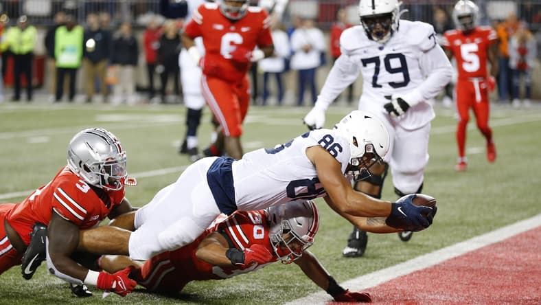 Oct 30, 2021; Columbus, Ohio, USA; Penn State Nittany Lions tight end Brenton Strange (86) dives in for the touchdown as Ohio State Buckeyes linebacker Teradja Mitchell (3)and linebacker Cody Simon (30)tackle him during the first quarter at Ohio Stadium. Mandatory Credit: Joseph Maiorana-USA TODAY Sports