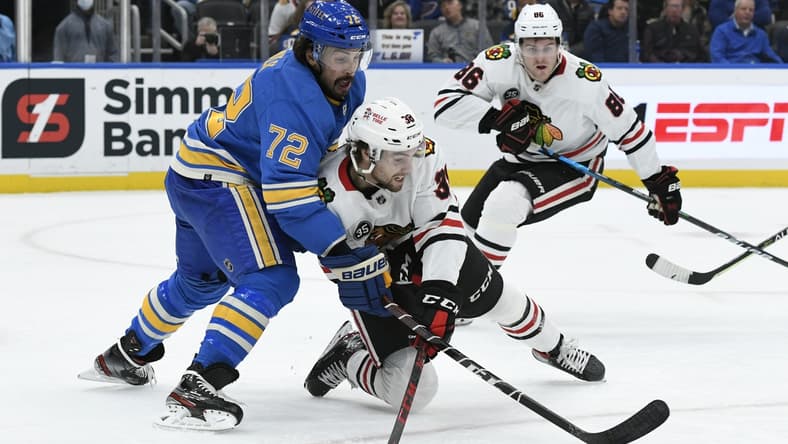 Oct 30, 2021; St. Louis, Missouri, USA; Chicago Blackhawks left wing Brandon Hagel (38) battles St. Louis Blues defenseman Justin Faulk (72) during the first period at Enterprise Center. Mandatory Credit: Jeff Le-USA TODAY Sports