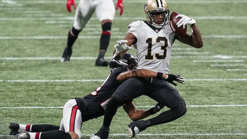 Dec 6, 2020; Atlanta, Georgia, USA; New Orleans Saints wide receiver Michael Thomas (13) holds on to the ball while being tackled by Atlanta Falcons cornerback A.J. Terrell (24)  during the second half at Mercedes-Benz Stadium. Mandatory Credit: Dale Zanine-USA TODAY Sports