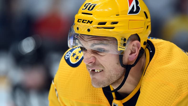 Feb 13, 2021; Nashville, Tennessee, USA; Nashville Predators defenseman Mark Borowiecki (90) lines up for a face off against the Detroit Red Wings during the second period at Bridgestone Arena. Mandatory Credit: Christopher Hanewinckel-USA TODAY Sports