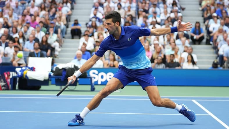 Sep 12, 2021; Flushing, NY, USA; Novak Djokovic of Serbia hits a shot against Daniil Medvedev of Russia in the men's singles final on day fourteen of the 2021 U.S. Open tennis tournament at USTA Billie Jean King National Tennis Center. Mandatory Credit: Danielle Parhizkaran-USA TODAY Sports