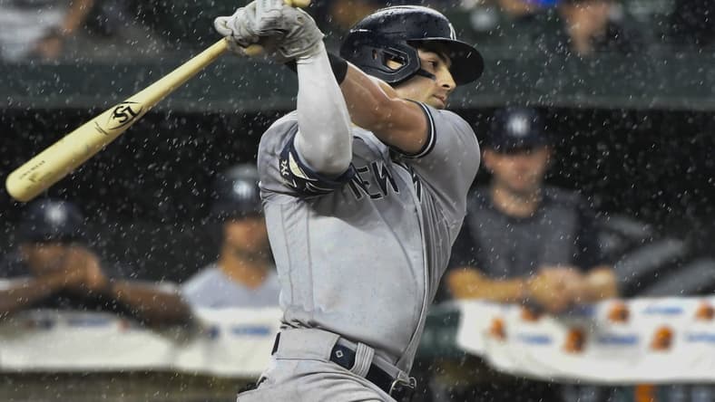 Sep 16, 2021; Baltimore, Maryland, USA; New York Yankees shortstop Tyler Wade (14) swings as rain comes down during the sixth inning against the Baltimore Orioles at Oriole Park at Camden Yards. Mandatory Credit: Tommy Gilligan-USA TODAY Sports