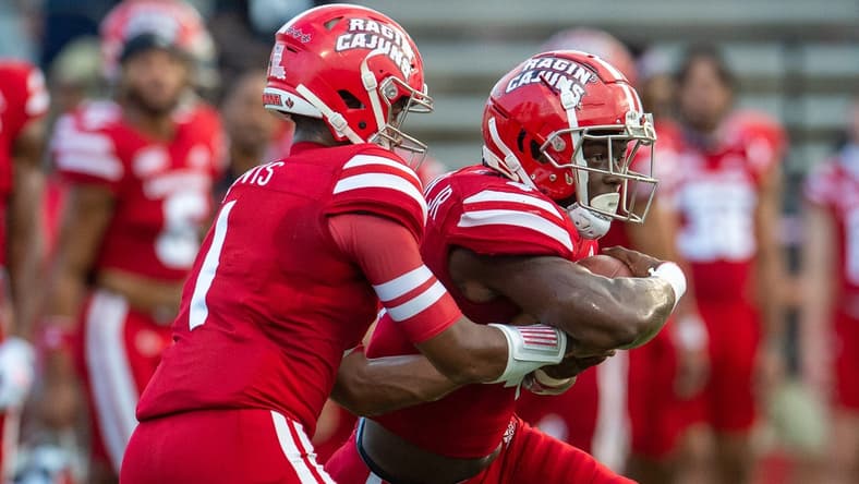 Louisiana Ragin' Cajuns football quarterback Levi Lewis (No. 1) hands the ball to Montrell Johnson Jr. (No. 4) during pre-game warm up as the Cajuns prepare to take on Ohio on Thursday, Sept. 16, 2021.

Cajuns Vs Ohio Football Pregame 5734
