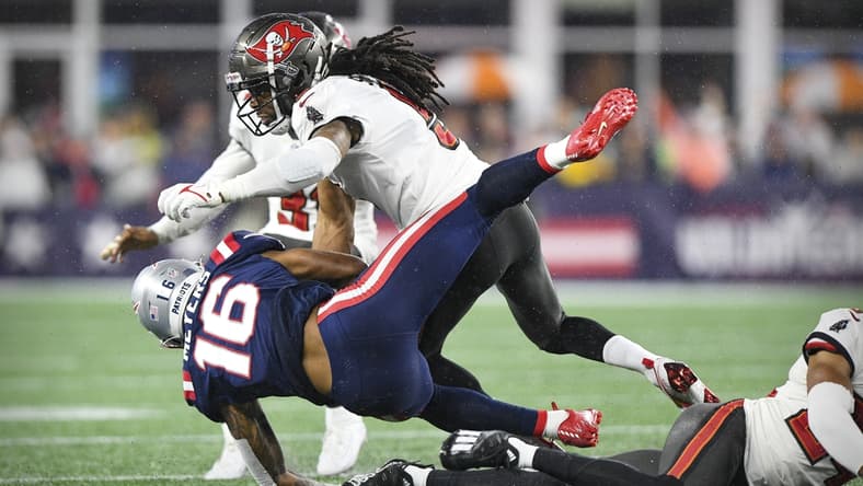 Oct 3, 2021; Foxboro, MA, USA; New England Patriots wide receiver Jakobi Meyers (16) is hit by Tampa Bay Buccaneers cornerback Richard Sherman (5) during the second quarter at Gillette Stadium.  Mandatory Credit: Brian Fluharty-USA TODAY Sports