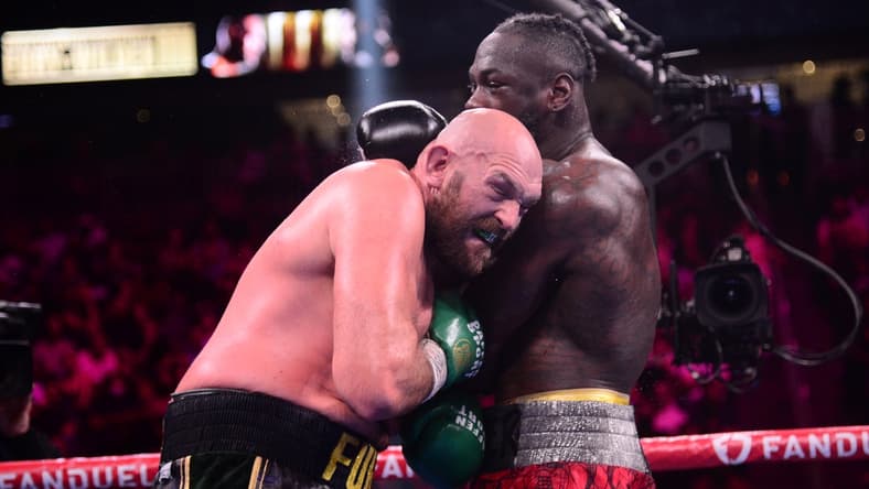 Oct 9, 2021; Las Vegas, Nevada, USA; Deontay Wilder (red/black trunks) and Tyson Fury (black/gold trunks) box during their WBC/Lineal heavyweight championship boxing match at T-Mobile Arena. Mandatory Credit: Joe Camporeale-USA TODAY Sports