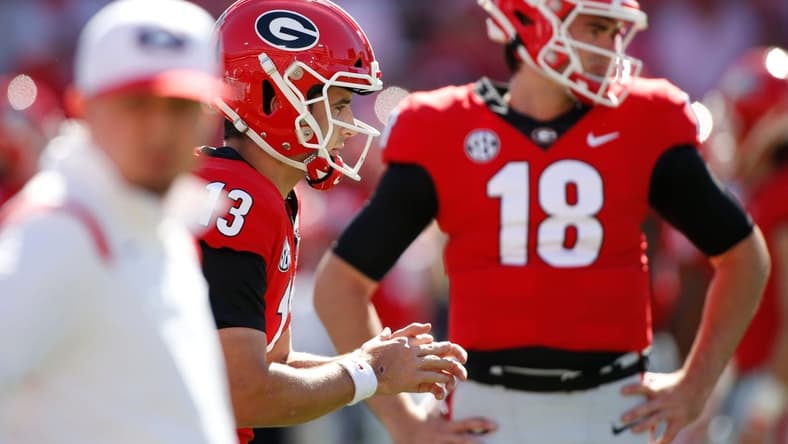 Georgia quarterback Stetson Bennett (13) warms up while Georgia quarterback JT Daniels (18) looks on before an NCAA college football game between Kentucky and Georgia in Athens, Ga., on Saturday, Oct. 16, 2021.
Syndication Online Athens