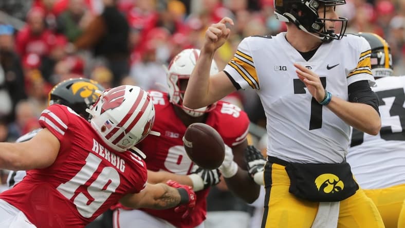 Wisconsin linebacker Nick Herbig (19) strips Iowa quarterback Spencer Petras (7) of the ball during the second quarter of their game on Saturday, Oct. 30, 2021, at Camp Randall Stadium in Madison. Wisconsin recovered the ball.

Mjs Uwgrid31 1 Jpg Uwgrid31
