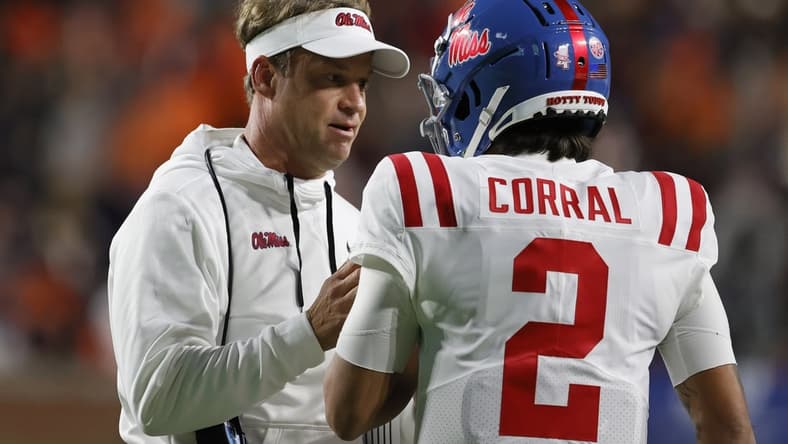 Oct 30, 2021; Auburn, Alabama, USA; Mississippi Rebels head coach Lane Kiffin talks with quarterback Matt Corral (2) during the second quarter against the Auburn Tigers at Jordan-Hare Stadium.  Mandatory Credit: John Reed-USA TODAY Sports