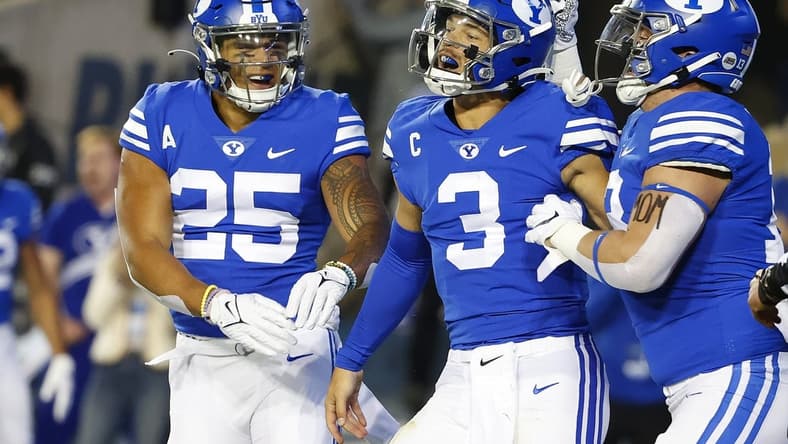 Oct 30, 2021; Provo, Utah, USA; Brigham Young Cougars running back Tyler Allgeier (25) congratulates Brigham Young Cougars quarterback Jaren Hall (3) for his first quarter touchdown against the Virginia Cavaliers at LaVell Edwards Stadium. Mandatory Credit: Jeffrey Swinger-USA TODAY Sports