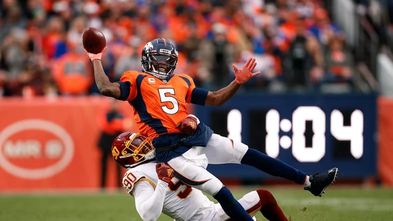 Oct 31, 2021; Denver, Colorado, USA; Denver Broncos quarterback Teddy Bridgewater (5) attempts to pass the ball as he is tackled by Washington Football Team defensive end Montez Sweat (90) in the fourth quarter at Empower Field at Mile High. Mandatory Credit: Isaiah J. Downing-USA TODAY Sports