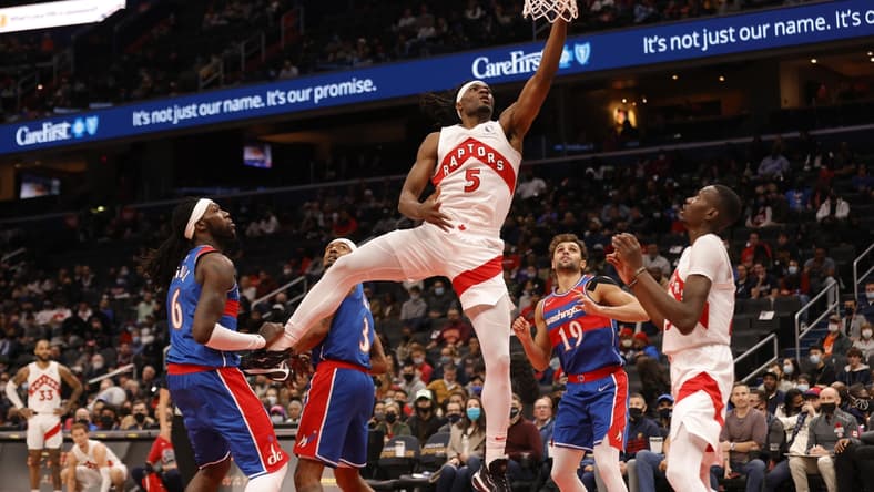 Nov 3, 2021; Washington, District of Columbia, USA; Toronto Raptors forward Precious Achiuwa (5) shoots the ball as Washington Wizards center Montrezl Harrell (6) looks on during the first quarter at Capital One Arena. Mandatory Credit: Geoff Burke-USA TODAY Sports