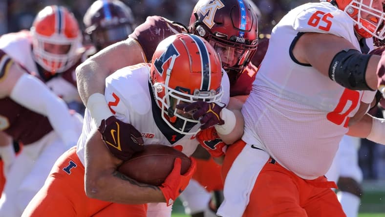 Nov 6, 2021; Minneapolis, Minnesota, USA; Illinois Fighting Illini running back Chase Brown (2) runs the ball against the Minnesota Golden Gophers in the second quarter at Huntington Bank Stadium. Mandatory Credit: Matt Krohn-USA TODAY Sports