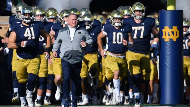 Nov 6, 2021; South Bend, Indiana, USA; Notre Dame Fighting Irish head coach Brian Kelly leads players onto the field before the game against the Navy Midshipmen at Notre Dame Stadium. Mandatory Credit: Matt Cashore-USA TODAY Sports
