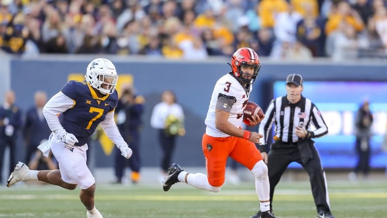 Nov 6, 2021; Morgantown, West Virginia, USA; Oklahoma State Cowboys quarterback Spencer Sanders (3) runs out of the pocket during the second quarter against the West Virginia Mountaineers at Mountaineer Field at Milan Puskar Stadium. Mandatory Credit: Ben Queen-USA TODAY Sports