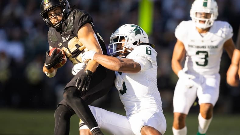 Nov 6, 2021; West Lafayette, Indiana, USA; Purdue Boilermakers wide receiver Jackson Anthrop (33) runs the ball while Michigan State Spartans linebacker Quavaris Crouch (6) defends in the first half at Ross-Ade Stadium. Mandatory Credit: Trevor Ruszkowski-USA TODAY Sports