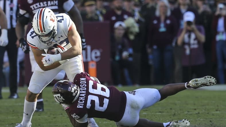 Nov 6, 2021; College Station, Texas, USA; Auburn Tigers tight end John Samuel Shenker (47) is tacked by Texas A&M Aggies defensive back Demani Richardson (26) in the second quarter at Kyle Field. Mandatory Credit: Thomas Shea-USA TODAY Sports