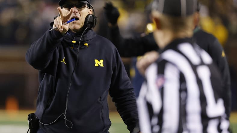 Nov 6, 2021; Ann Arbor, Michigan, USA;  Michigan Wolverines head coach Jim Harbaugh singles they will go for a two point conversion in the second half against the Indiana Hoosiers at Michigan Stadium. Mandatory Credit: Rick Osentoski-USA TODAY Sports