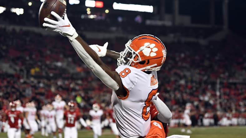 Nov 6, 2021; Louisville, Kentucky, USA; Clemson Tigers wide receiver Justyn Ross (8) stretches to catch an over thrown pass against the Louisville Cardinals during the second half at Cardinal Stadium. Clemson defeated Louisville 30-24. Mandatory Credit: Jamie Rhodes-USA TODAY Sports
