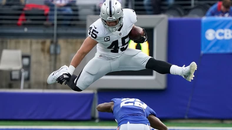 Nov 7, 2021; East Rutherford, N.J., USA;  Las Vegas Raiders fullback Alec Ingold (45) hurdles over New York Giants cornerback Adoree' Jackson (22) for yards in the second quarter at MetLife Stadium. Mandatory Credit: Robert Deutsch-USA TODAY Sports