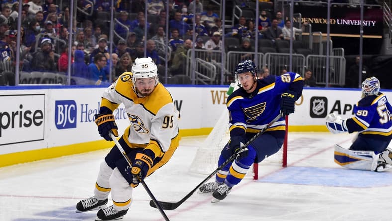 Nov 11, 2021; St. Louis, Missouri, USA; Nashville Predators center Matt Duchene (95) handles the puck as St. Louis Blues center Tyler Bozak (21) defends during the third period at Enterprise Center. Mandatory Credit: Jeff Curry-USA TODAY Sports