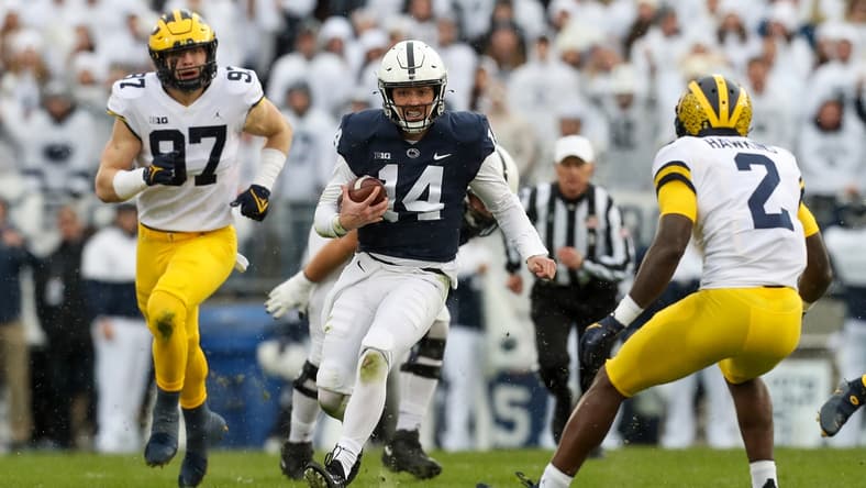 Nov 13, 2021; University Park, Pennsylvania, USA; Penn State Nittany Lions quarterback Sean Clifford (14) runs with the ball during the first quarter against the Michigan Wolverines at Beaver Stadium. Mandatory Credit: Matthew OHaren-USA TODAY Sports