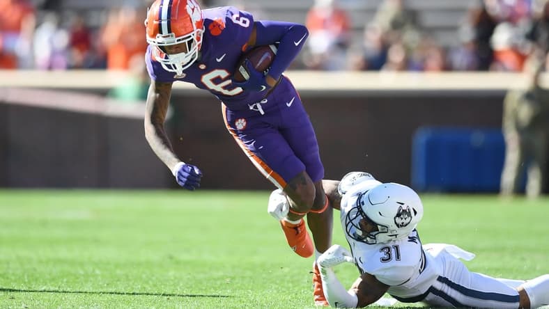 Nov 13, 2021; Clemson, South Carolina, USA; Clemson Tigers wide receiver E.J. Williams (6) is tackled by Connecticut Huskies defensive back Malik Dixon (31) during the first quarter at Memorial Stadium. Mandatory Credit: Adam Hagy-USA TODAY Sports