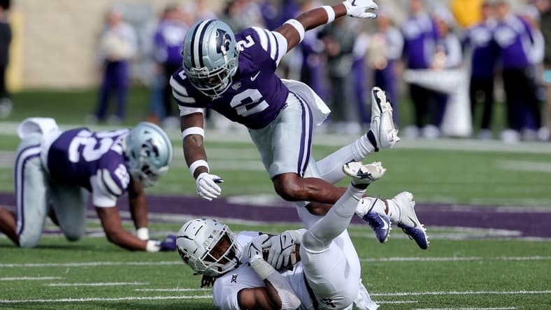 Nov 13, 2021; Manhattan, Kansas, USA; West Virginia Mountaineers wide receiver Winston Wright Jr. (1) is tackled by Kansas State Wildcats defensive back Russ Yeast (2) during the first quarter at Bill Snyder Family Football Stadium. Mandatory Credit: Scott Sewell-USA TODAY Sports