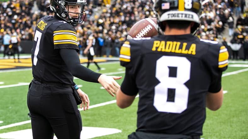 Iowa quarterback Spencer Petras (7) tosses a ball to teammate Alex Padilla (8) as they warm up before a NCAA Big Ten Conference football game against Minnesota, Saturday, Nov. 13, 2021, at Kinnick Stadium in Iowa City, Iowa.
211113 Minn Iowa Fb 097 Jpg