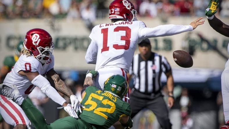 Nov 13, 2021; Waco, Texas, USA; Baylor Bears linebacker Matt Jones (52) knocks the ball away from Oklahoma Sooners quarterback Caleb Williams (13) during the second half at McLane Stadium. Mandatory Credit: Jerome Miron-USA TODAY Sports