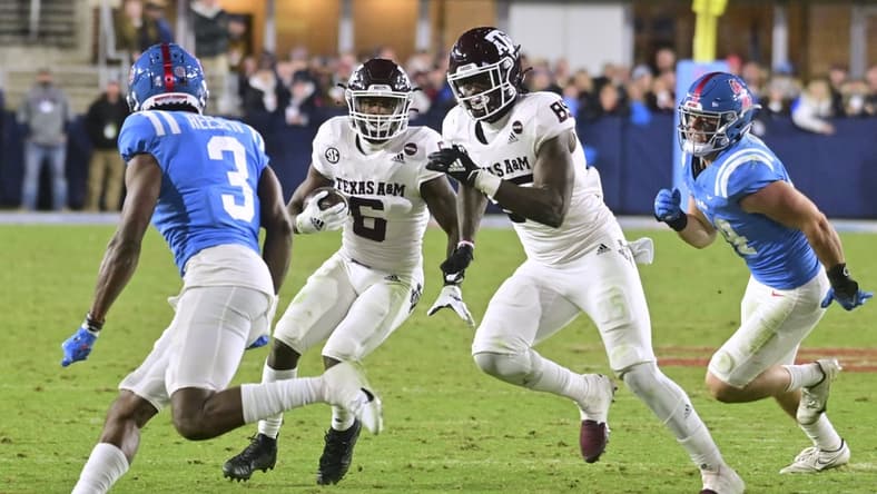 Nov 13, 2021; Oxford, Mississippi, USA; Texas A&M Aggies running back Devon Achane (6) runs the ball against Mississippi Rebels defensive back Otis Reese (3) during the third quarter at Vaught-Hemingway Stadium. Mandatory Credit: Matt Bush-USA TODAY Sports