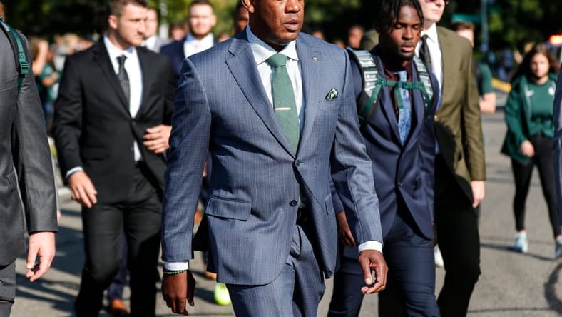 Michigan State head coach Mel Tucker and players march towards Spartan Stadium before the Youngstown State game in East Lansing on Saturday, Sept. 11, 2021. Michigan State won the game, 42-14.