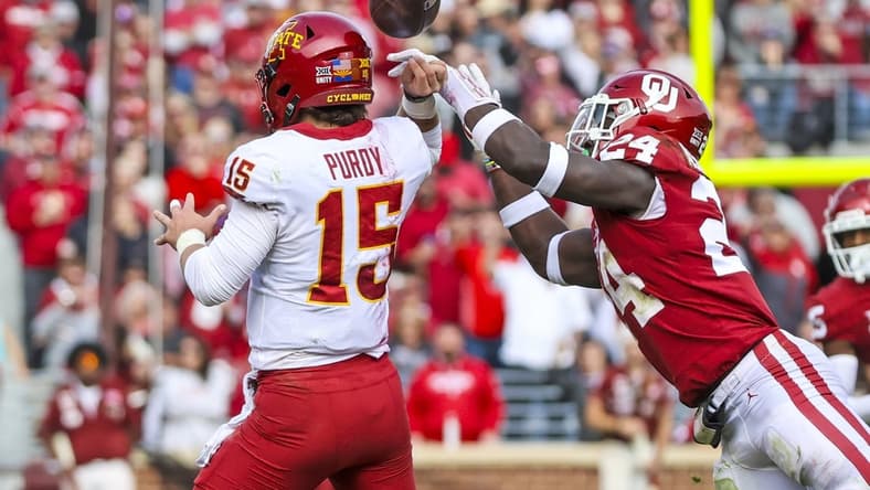 Nov 20, 2021; Norman, Oklahoma, USA; Oklahoma Sooners linebacker Brian Asamoah (24) causes Iowa State Cyclones quarterback Brock Purdy (15) to fumble during the second quarter at Gaylord Family-Oklahoma Memorial Stadium. Mandatory Credit: Kevin Jairaj-USA TODAY Sports