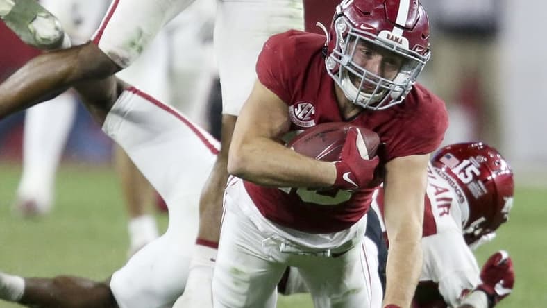 Nov 20, 2021; Tuscaloosa, Alabama, USA; Arkansas Razorbacks defensive back Simeon Blair (15) and defensive back LaDarrius Bishop (24) tackle Alabama Crimson Tide wide receiver Slade Bolden (18) at Bryant-Denny Stadium. Alabama won 42-35. Mandatory Credit: Gary Cosby Jr.-USA TODAY Sports