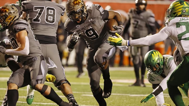 Nov 20, 2021; Salt Lake City, Utah, USA; Utah Utes running back Tavion Thomas (9) runs for a first quarter touchdown against the Oregon Ducks at Rice-Eccles Stadium. Mandatory Credit: Jeffrey Swinger-USA TODAY Sports