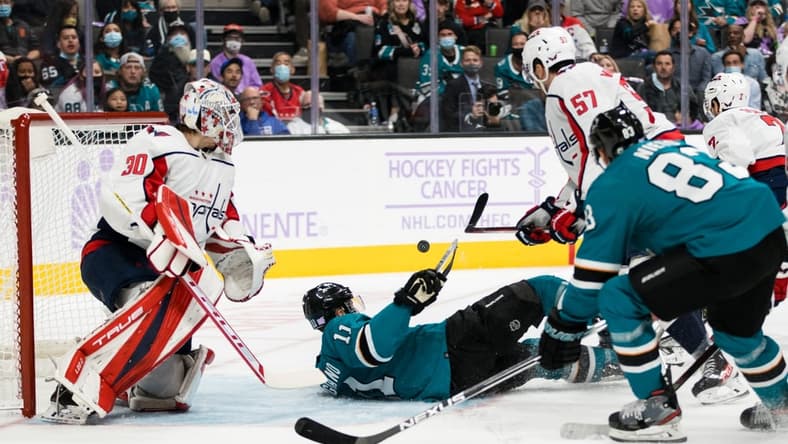 Nov 20, 2021; San Jose, California, USA; San Jose Sharks center Andrew Cogliano (11) falls as Washington Capitals goaltender Ilya Samsonov (30) and defenseman Trevor van Riemsdyk (57) defend during the second period at SAP Center at San Jose. Mandatory Credit: John Hefti-USA TODAY Sports