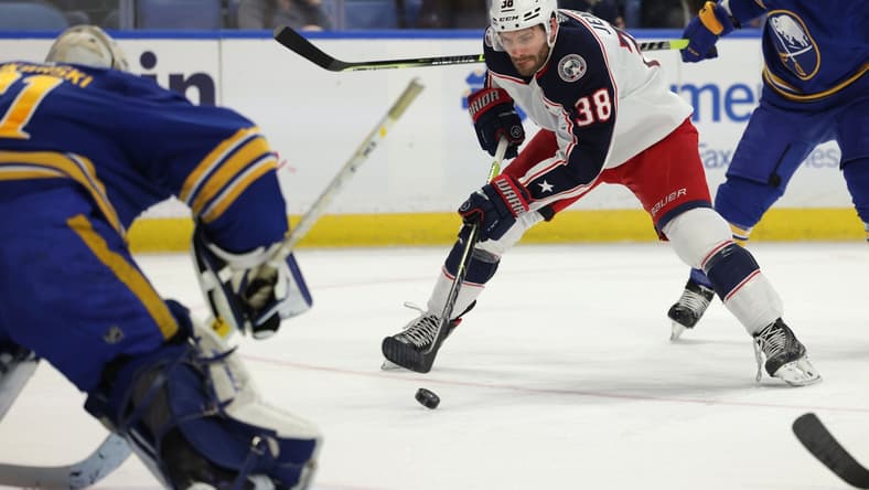Nov 22, 2021; Buffalo, New York, USA; Columbus Blue Jackets center Boone Jenner (38) moves in for a shot on Buffalo Sabres goaltender Dustin Tokarski (31) during the first period at KeyBank Center. Mandatory Credit: Timothy T. Ludwig-USA TODAY Sports