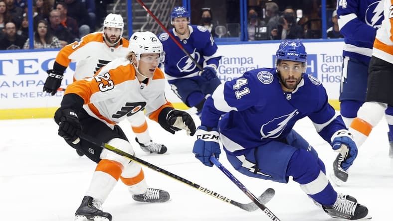 Nov 23, 2021; Tampa, Florida, USA; Tampa Bay Lightning center Pierre-Edouard Bellemare (41) and Philadelphia Flyers left wing Oskar Lindblom (23) skate after the puck during the first period at Amalie Arena. Mandatory Credit: Kim Klement-USA TODAY Sports