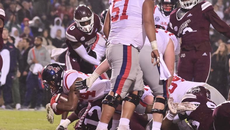 Nov 25, 2021; Starkville, Mississippi, USA; Mississippi Rebels running back Snoop Conner (24) dives into the endzone against the Mississippi State Bulldogs during the second quarter at Davis Wade Stadium at Scott Field. Mandatory Credit: Matt Bush-USA TODAY Sports