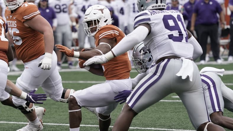 Nov 26, 2021; Austin, Texas, USA; Texas Longhorns running back Roschon Johnson (2) runs for yardage during the first half against the Kansas State Wildcats at Darrell K Royal-Texas Memorial Stadium. Mandatory Credit: Scott Wachter-USA TODAY Sports