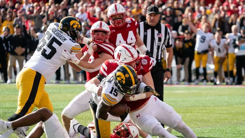 Nov 26, 2021; Lincoln, Nebraska, USA; Iowa Hawkeyes running back Tyler Goodson (15) is stopped short of the goal line by Nebraska Cornhuskers defenders during the first quarter at Memorial Stadium. Mandatory Credit: Dylan Widger-USA TODAY Sports