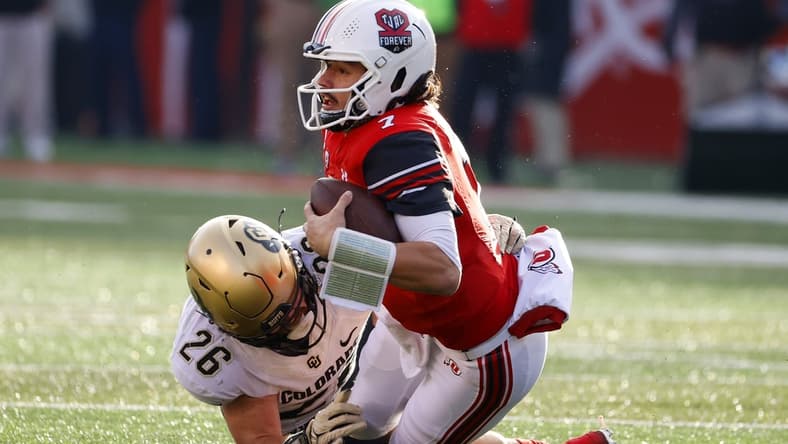 Nov 26, 2021; Salt Lake City, Utah, USA; Utah Utes quarterback Cameron Rising (7) tries for the first down against Colorado Buffaloes linebacker Carson Wells (26) in the second quarter at Rice-Eccles Stadium. Mandatory Credit: Jeffrey Swinger-USA TODAY Sports